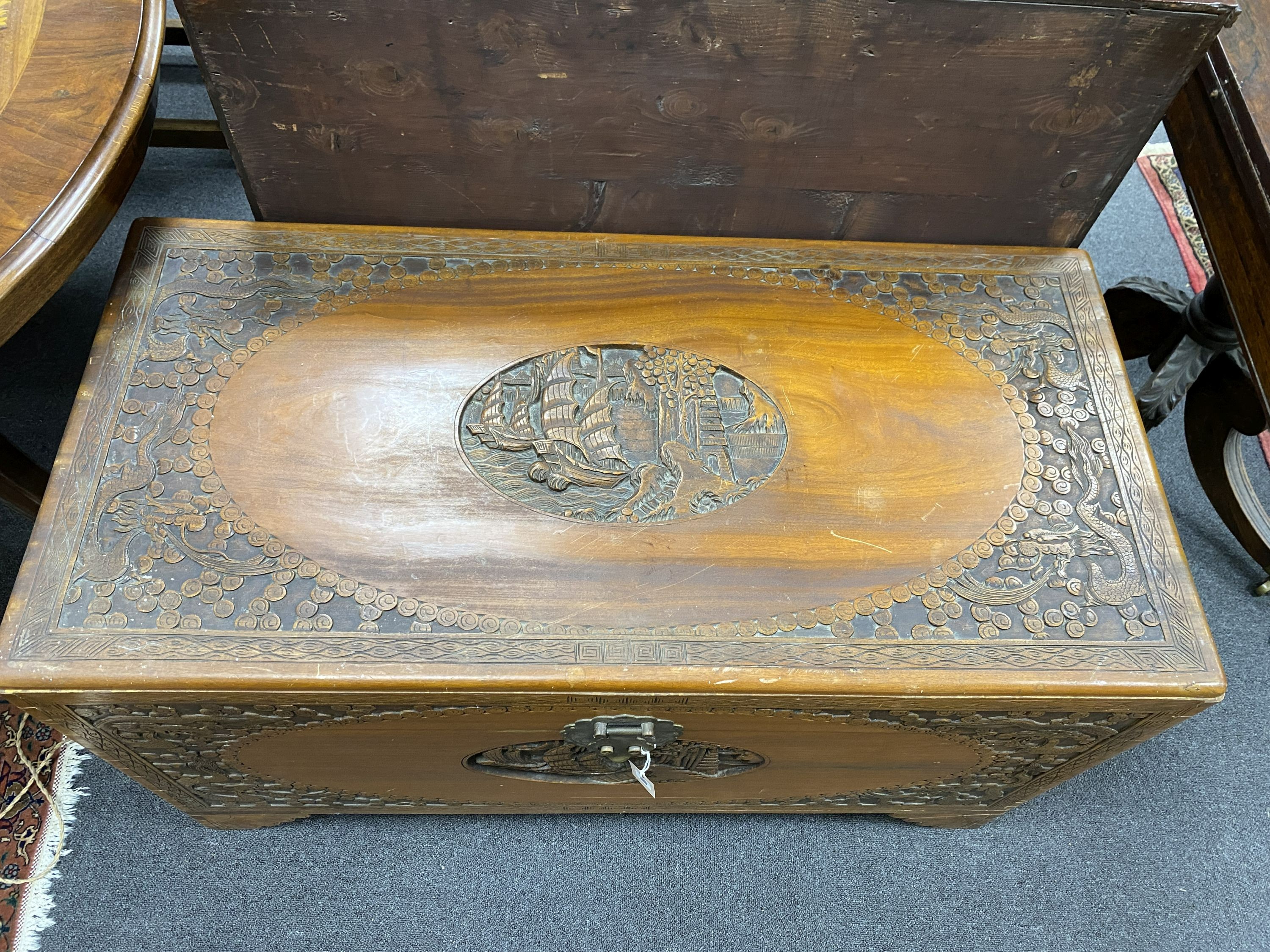 A Chinese carved camphorwood chest, length 104cm, depth 51cm, height 60cm